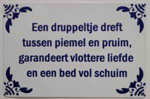 Dreft tussen piemel en pruim wandbord van metaal